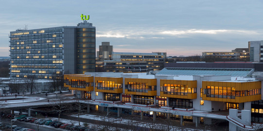 The picture shows the cafeteria and the Math Tower at night.